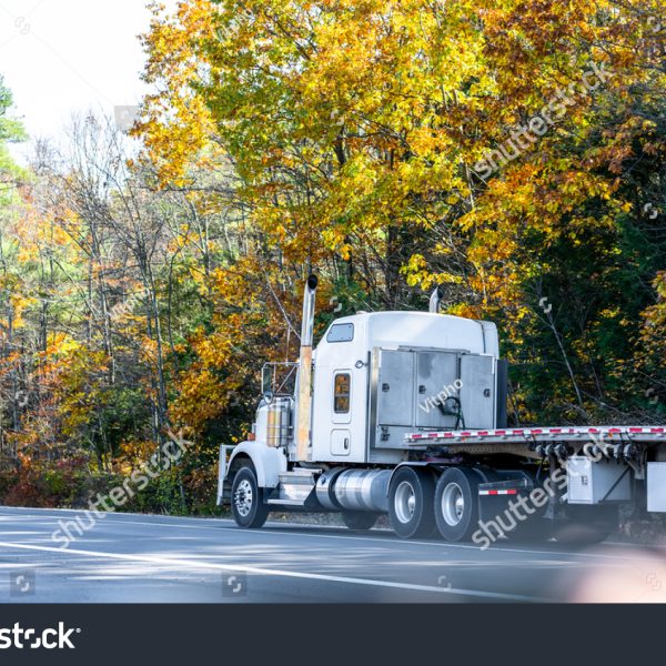 stock-photo-classic-white-long-hauler-big-rig-industrial-semi-truck-tractor-with-low-cab-and-empty-flat-bed-1877091895