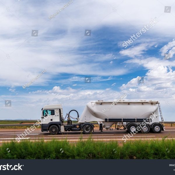 stock-photo-tanker-truck-for-the-transport-of-bulk-cement-circulating-on-a-highway-2295987337